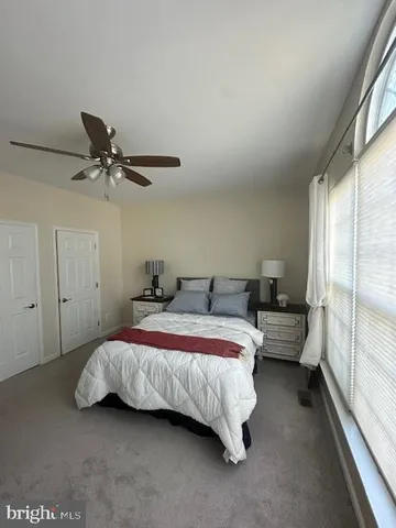 a bedroom with bed and window
