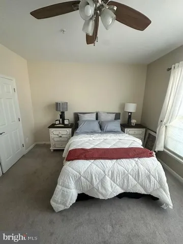 a bedroom with bed and window