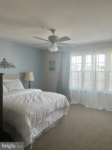 a spacious bedroom with a bed and a large window