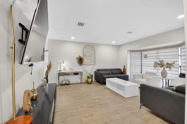 a living room with furniture and a floor to ceiling window