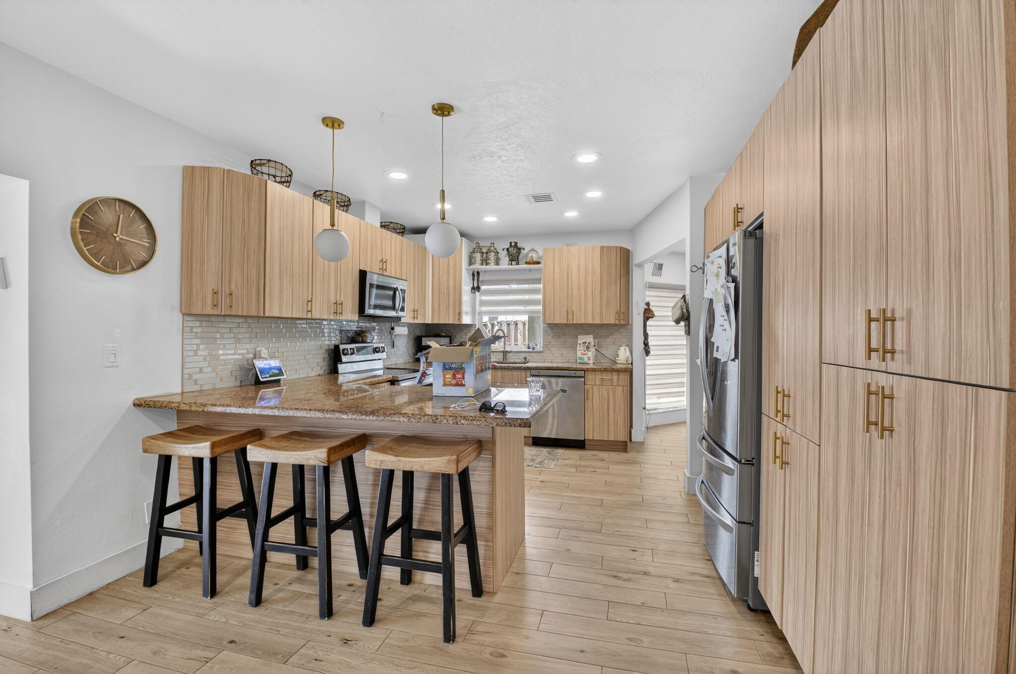 21724 Little Bear Way Boca Raton, FL 33428 - Photo 16 of 47 a kitchen with stainless steel appliances granite countertop a table chairs refrigerator and sink