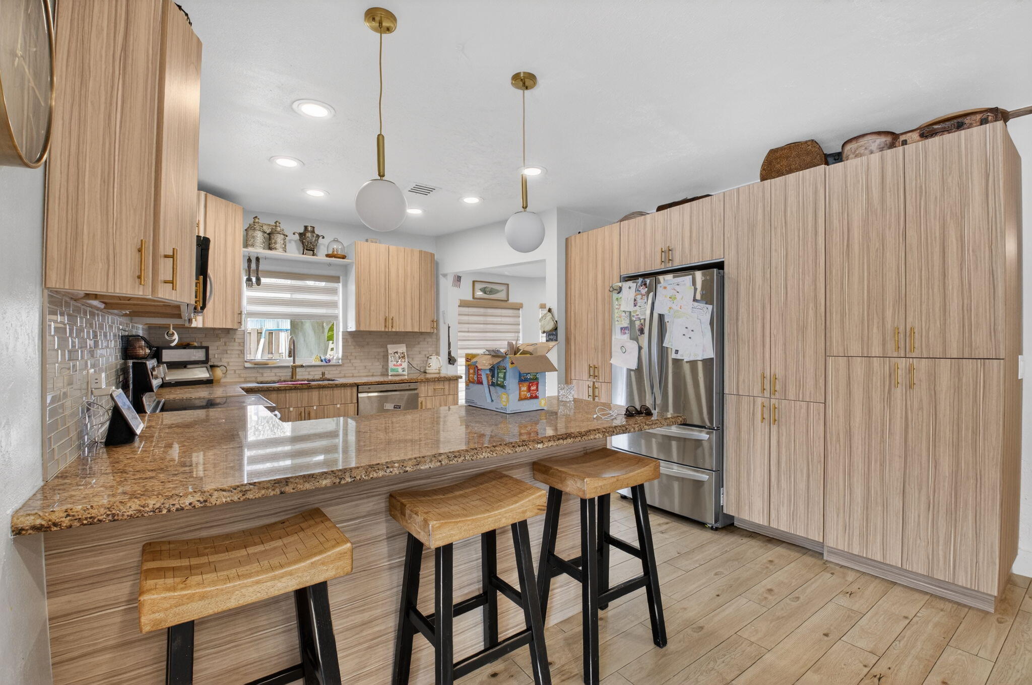 21724 Little Bear Way Boca Raton, FL 33428 - Photo 17 of 47 a kitchen with stainless steel appliances granite countertop a refrigerator a sink dishwasher a stove and white cabinets with wooden floor