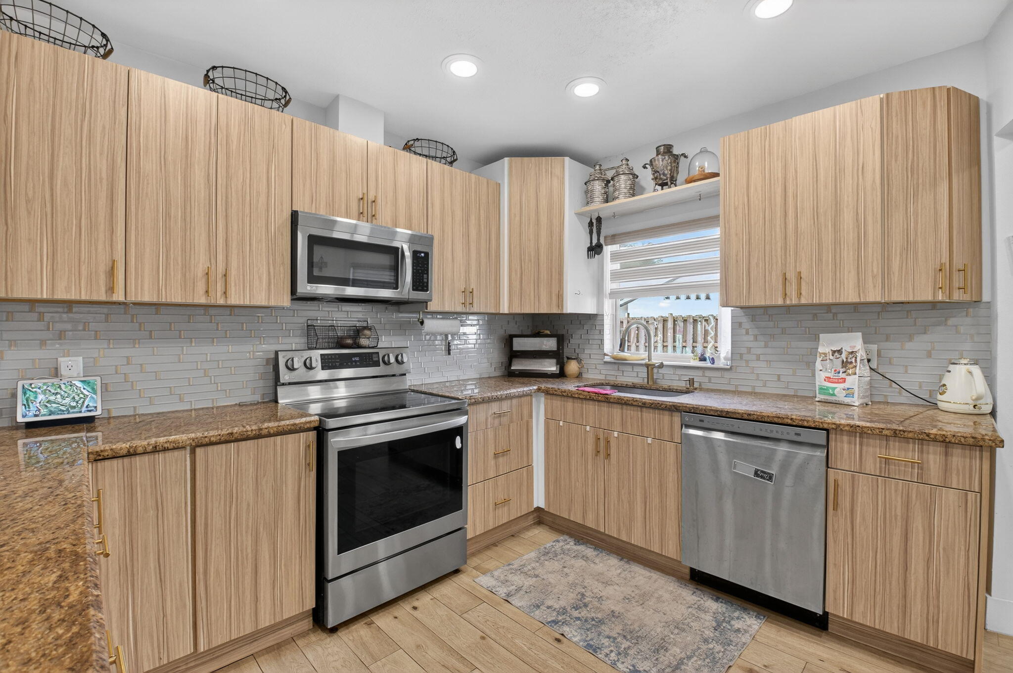 21724 Little Bear Way Boca Raton, FL 33428 - Photo 18 of 47 a kitchen with stainless steel appliances granite countertop a stove sink microwave and cabinets