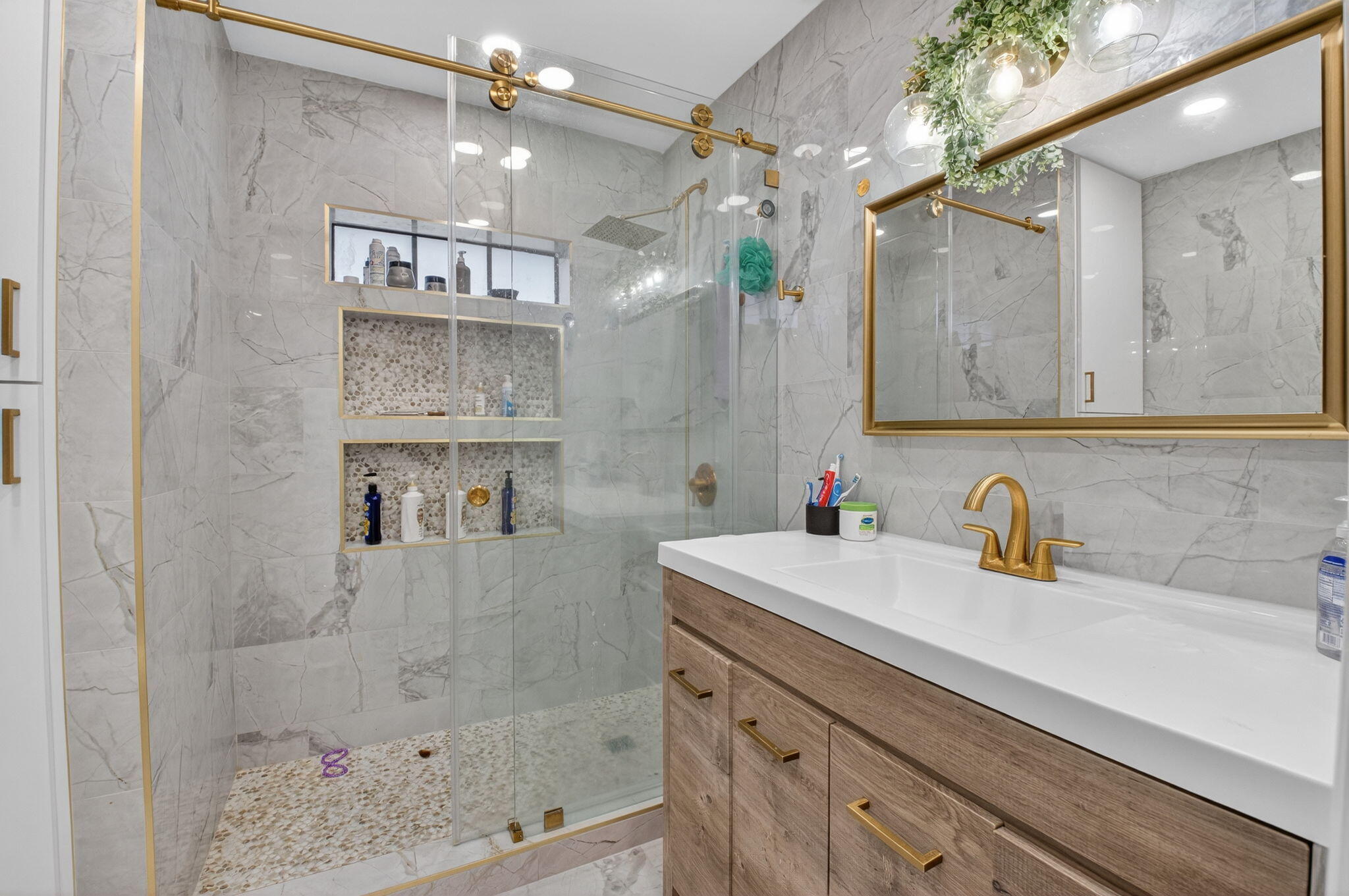 21724 Little Bear Way Boca Raton, FL 33428 - Photo 25 of 47 a bathroom with a sink a mirror and shower