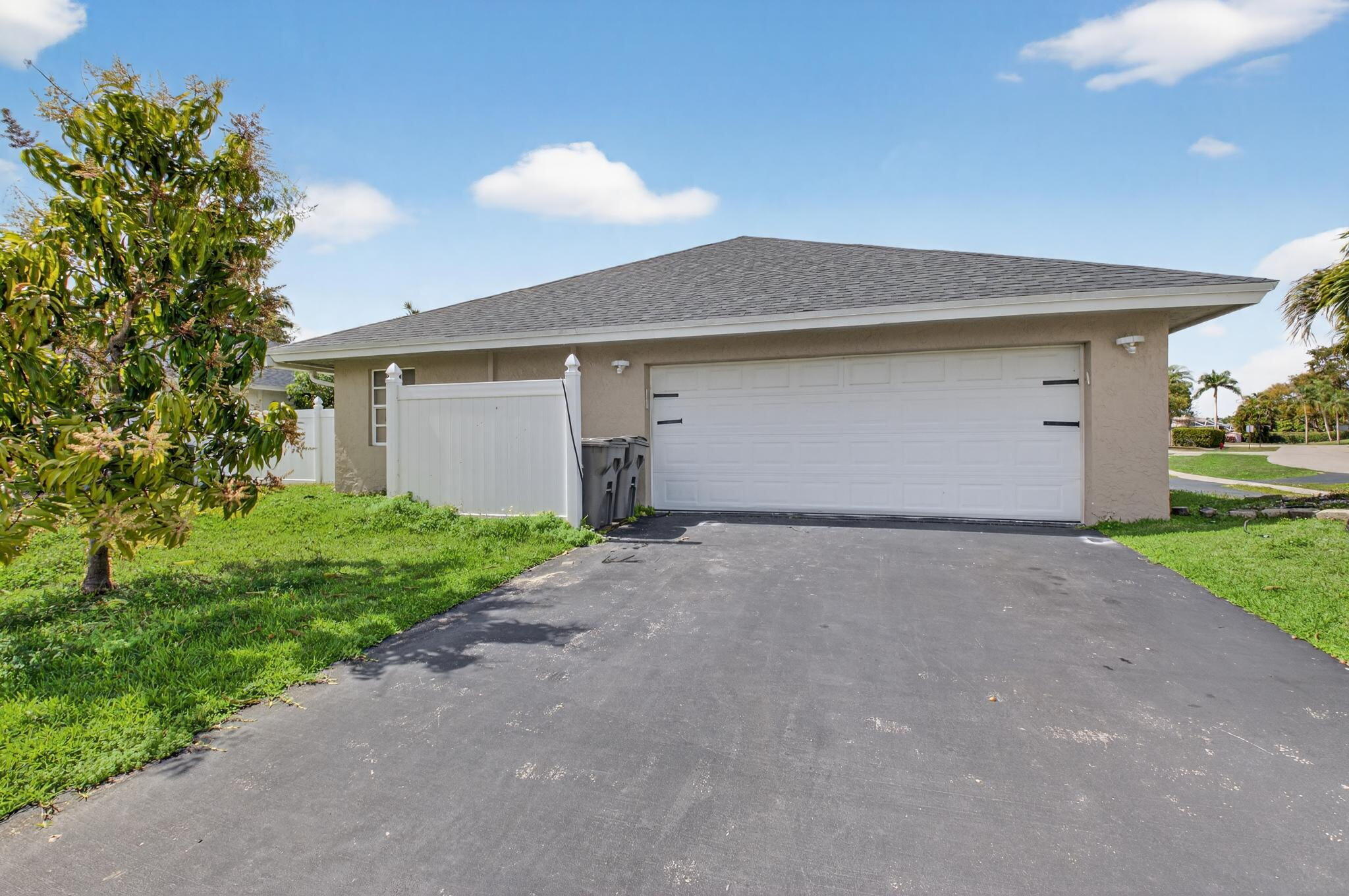 21724 Little Bear Way Boca Raton, FL 33428 - Photo 3 of 47 a front view of house with yard and trees