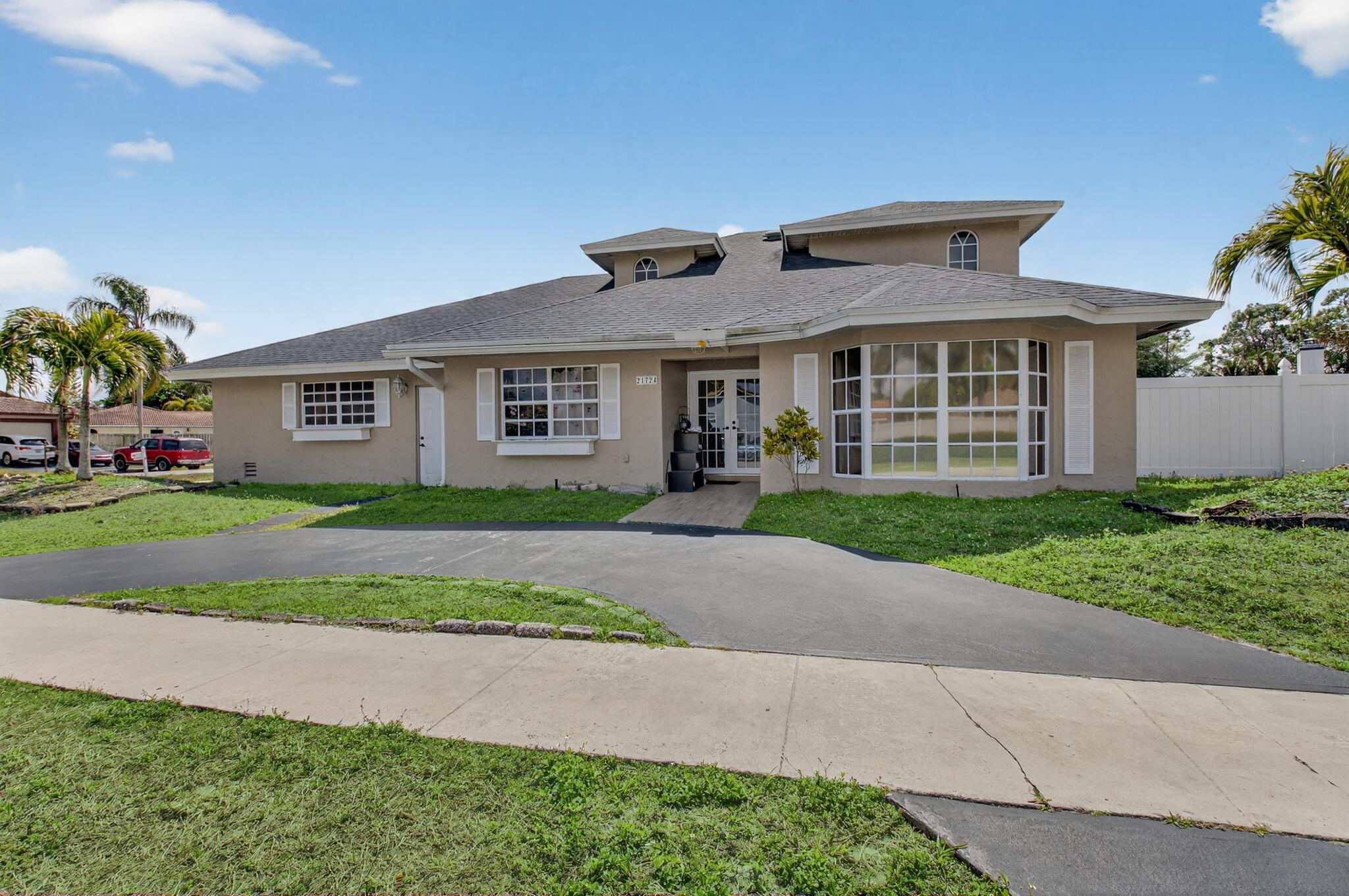 21724 Little Bear Way Boca Raton, FL 33428 - Photo 4 of 47 a front view of house with yard and green space