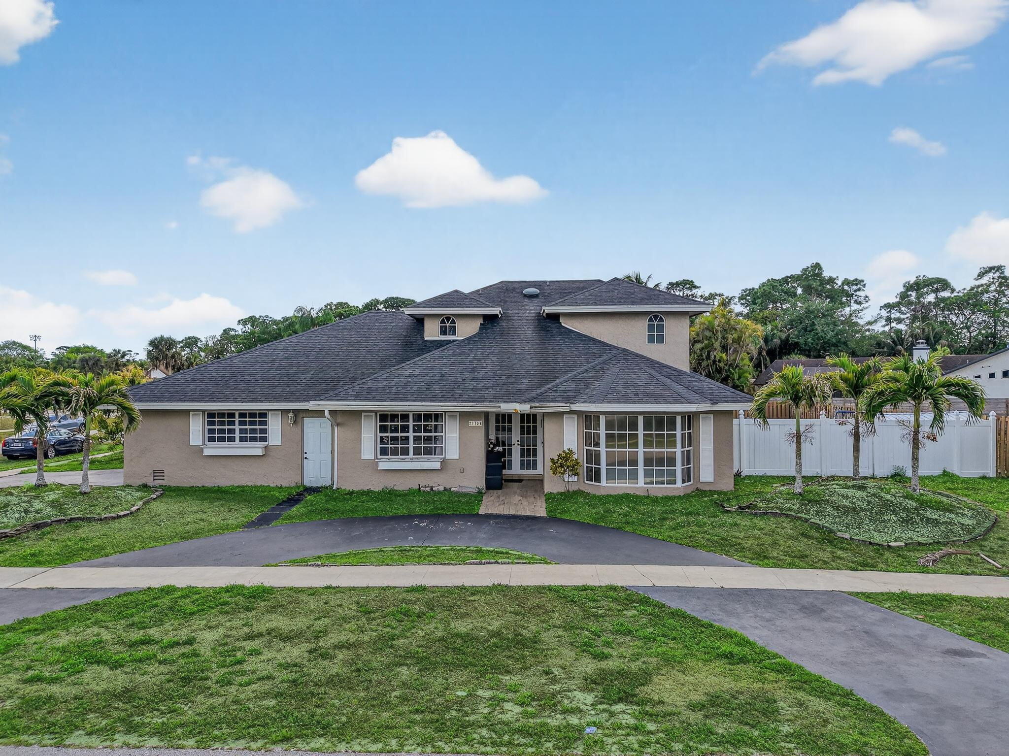 21724 Little Bear Way Boca Raton, FL 33428 - Photo 6 of 47 a front view of a house with a garden and plants