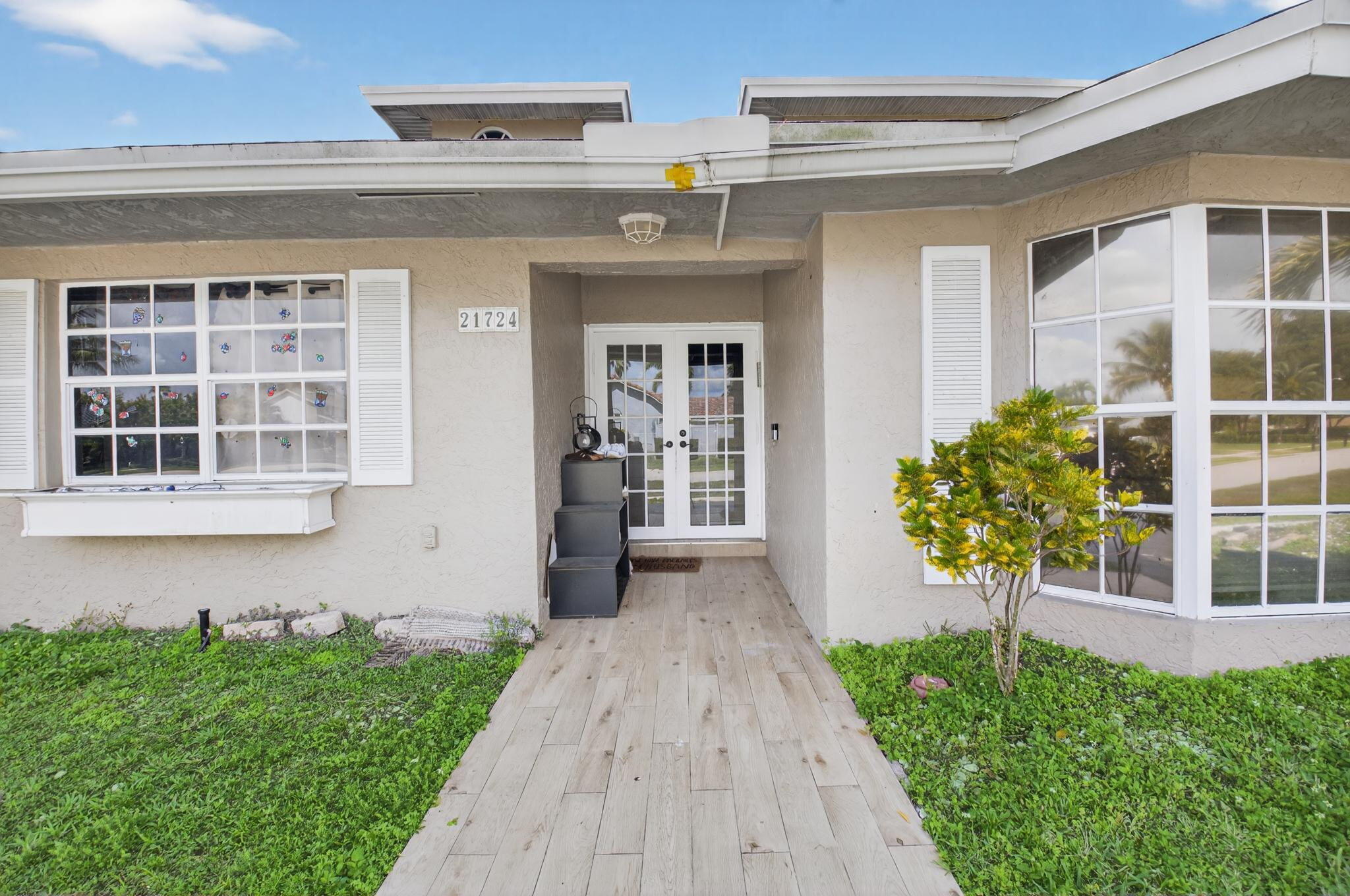 21724 Little Bear Way Boca Raton, FL 33428 - Photo 10 of 47 a front view of a house with garden