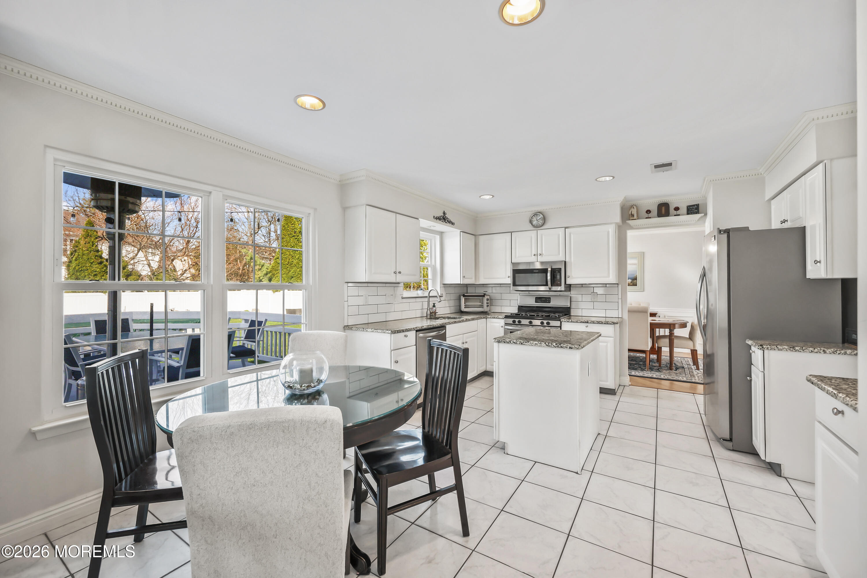 17 Sun Hollow Road Howell, NJ 07731 - Photo 12 of 43 a kitchen with a dining table chairs and refrigerator