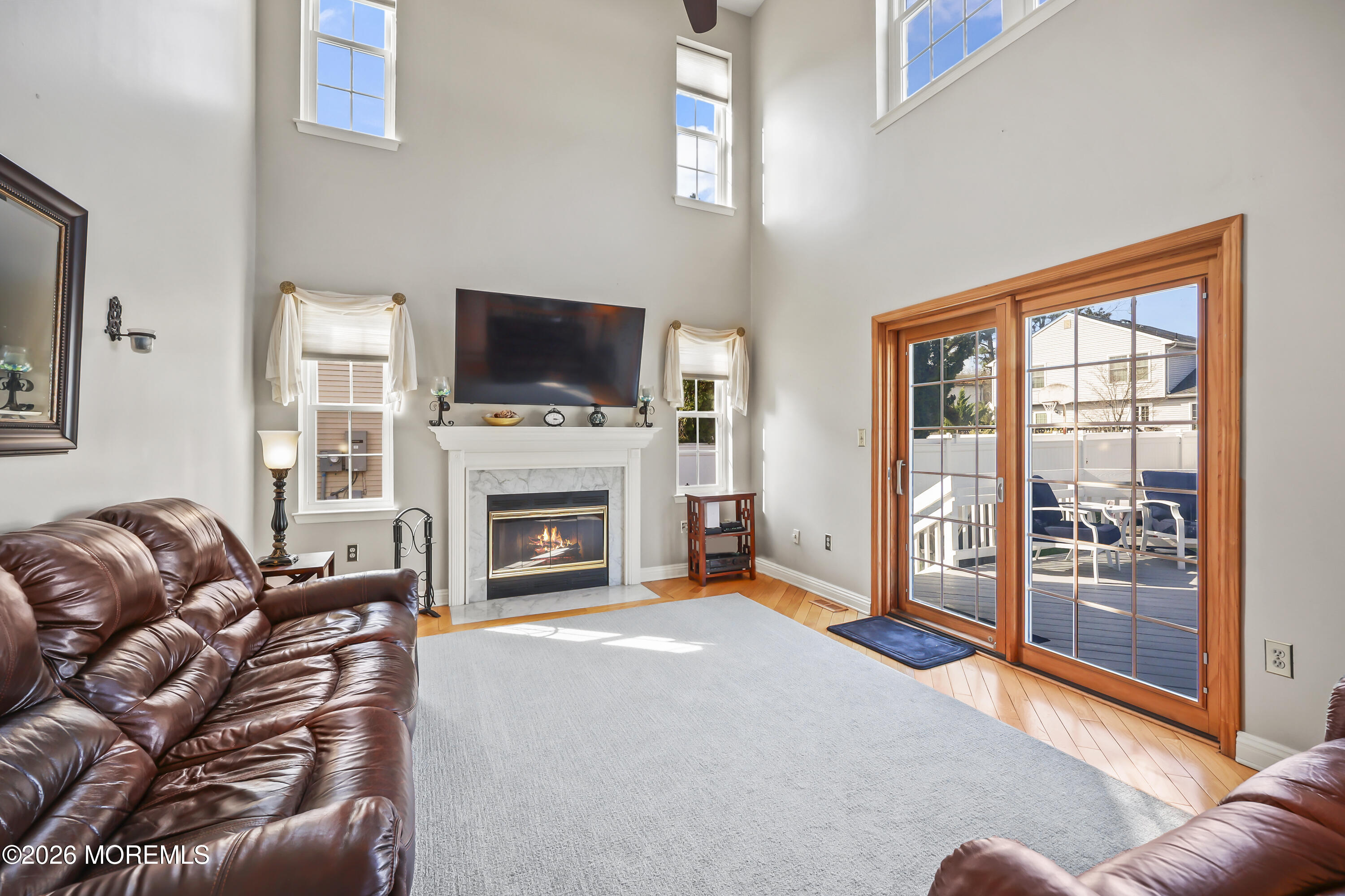 17 Sun Hollow Road Howell, NJ 07731 - Photo 14 of 43 a living room with furniture a fireplace and a flat screen tv