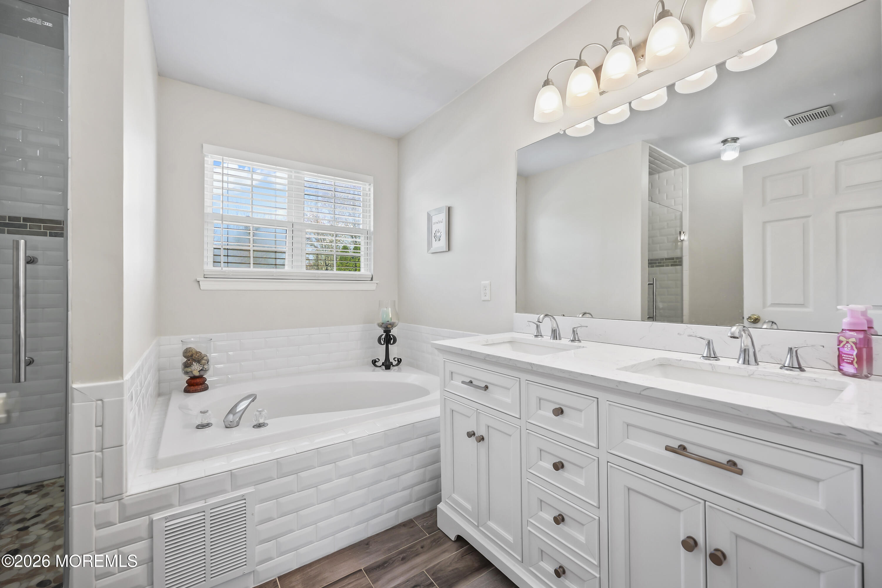 17 Sun Hollow Road Howell, NJ 07731 - Photo 24 of 43 a bathroom with a tub a double vanity sink double vanity and a mirror