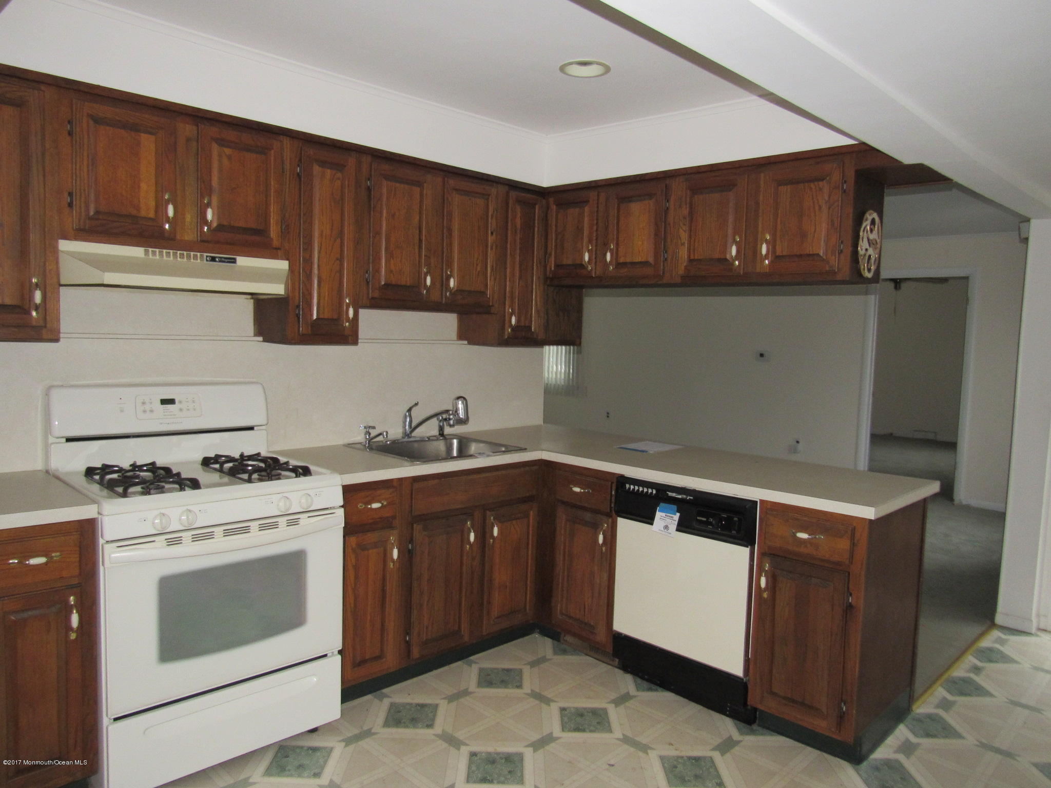 1136 Minnesink Road Manasquan, NJ 08736 - Photo 3 of 9 a kitchen with a stove sink and cabinets