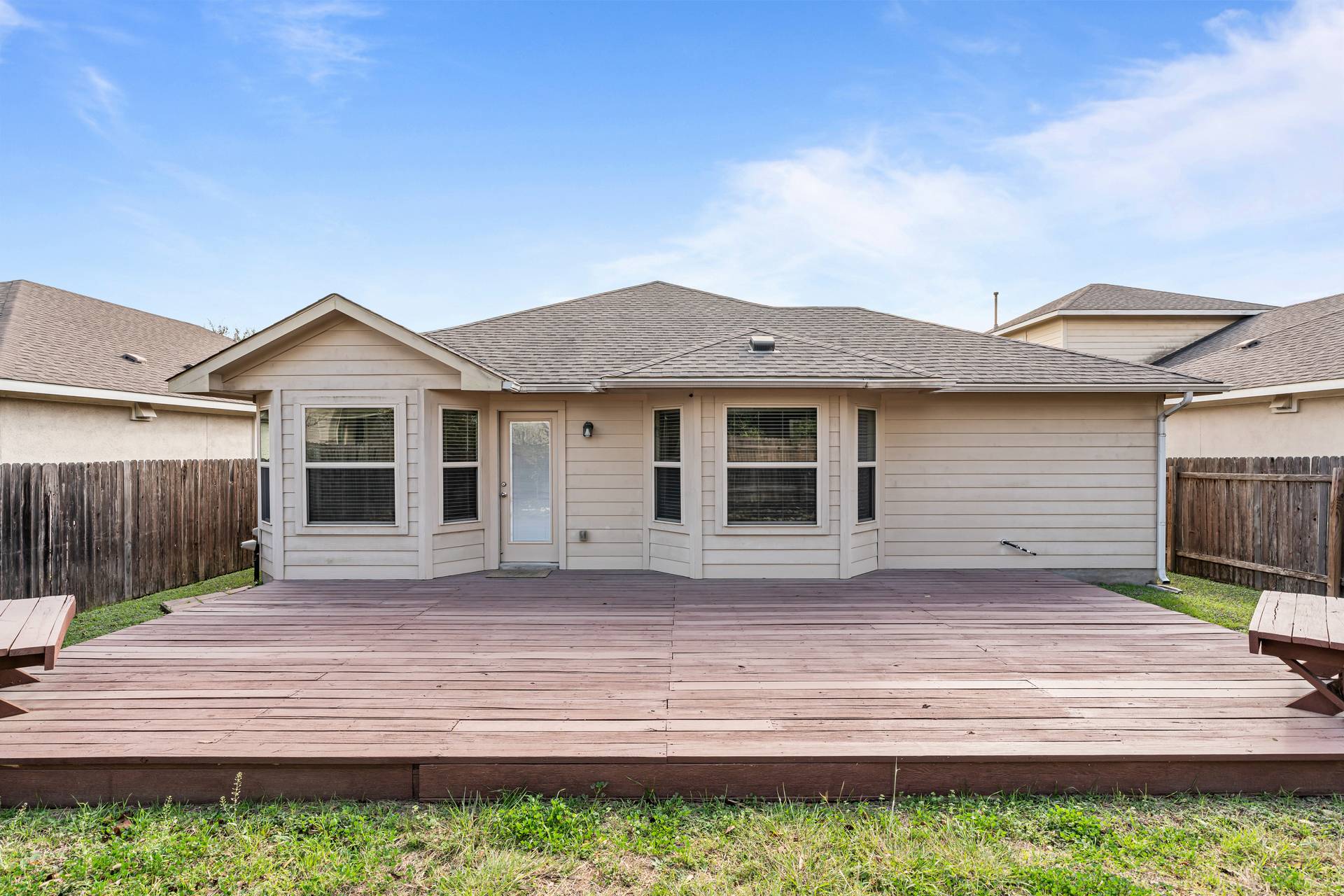 180 Fletcher Bend Buda, TX 78610 - Photo 27 of 36 a front view of a house with a garden and yard