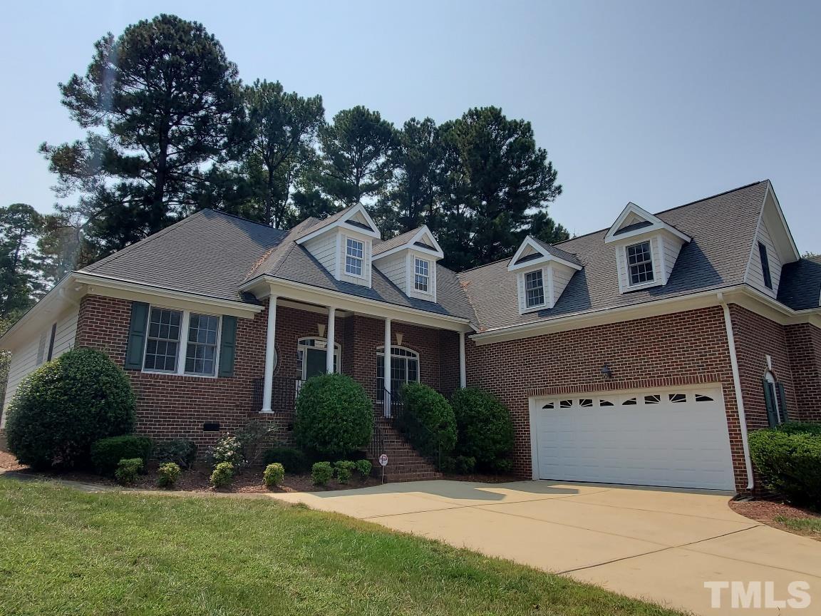 263 Waterville Street Raleigh, NC 27603 - Photo 1 of 18 a front view of a house with a yard and garage
