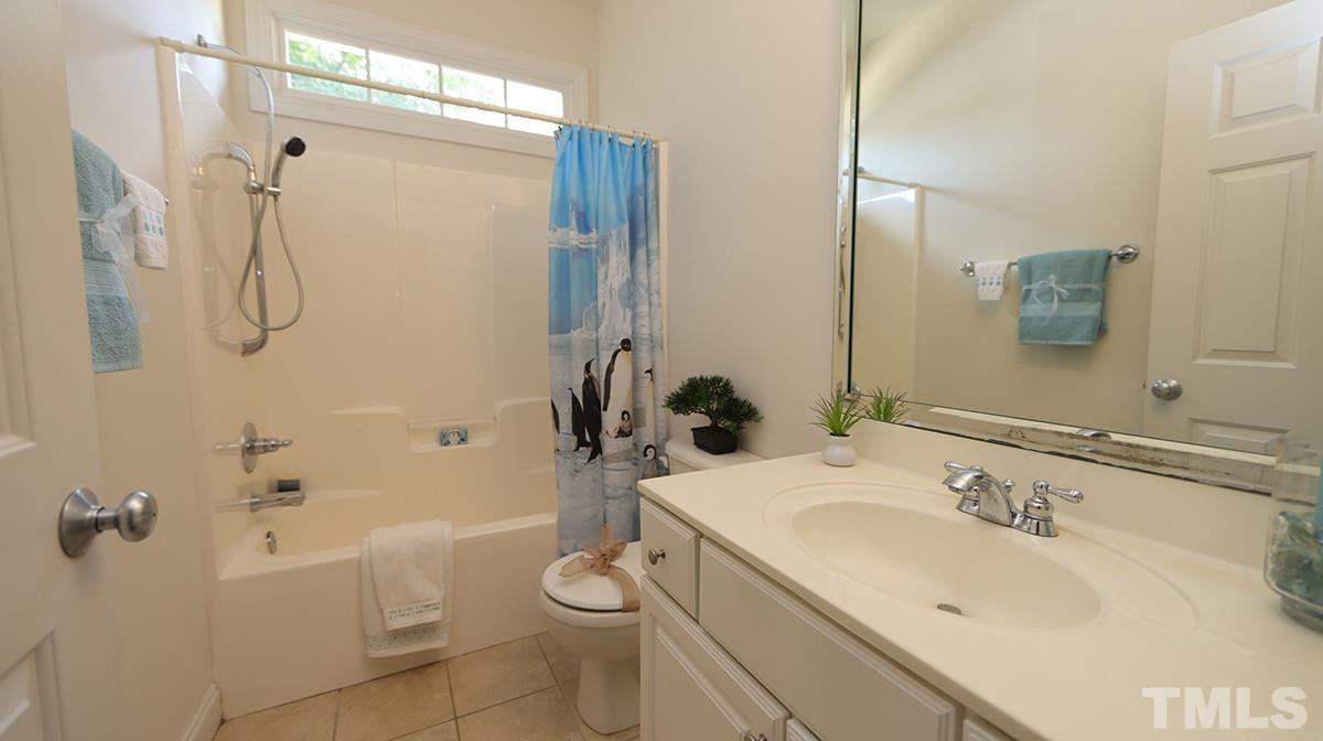 263 Waterville Street Raleigh, NC 27603 - Photo 10 of 18 a bathroom with a sink toilet and shower