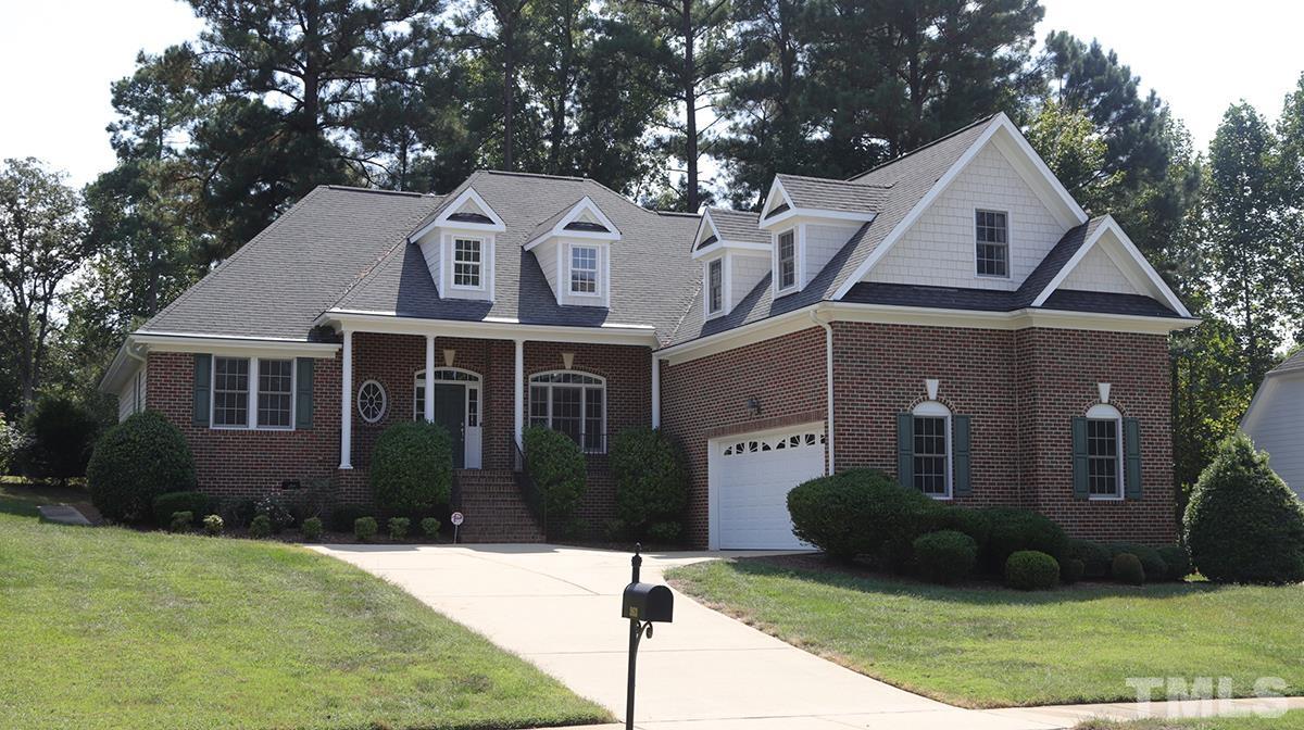 263 Waterville Street Raleigh, NC 27603 - Photo 16 of 18 a front view of a house with a yard and garage
