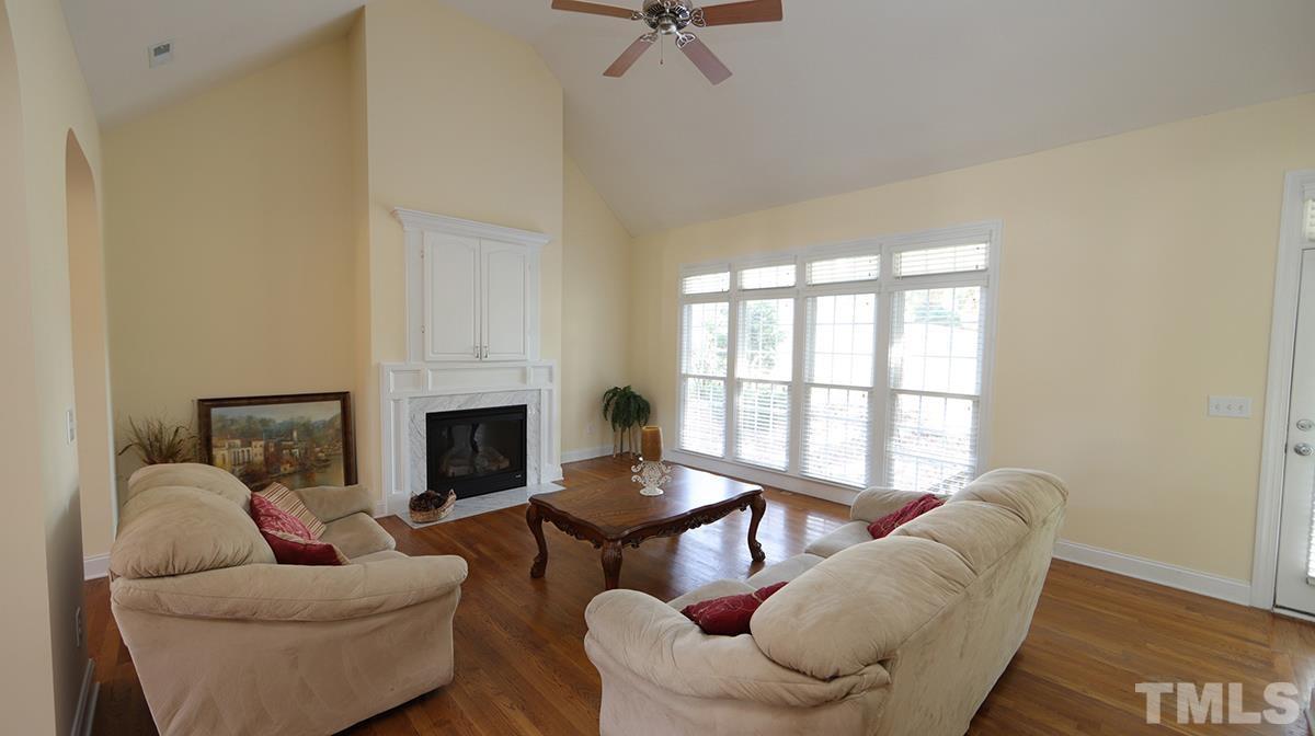 263 Waterville Street Raleigh, NC 27603 - Photo 5 of 18 a living room with furniture fireplace and a table