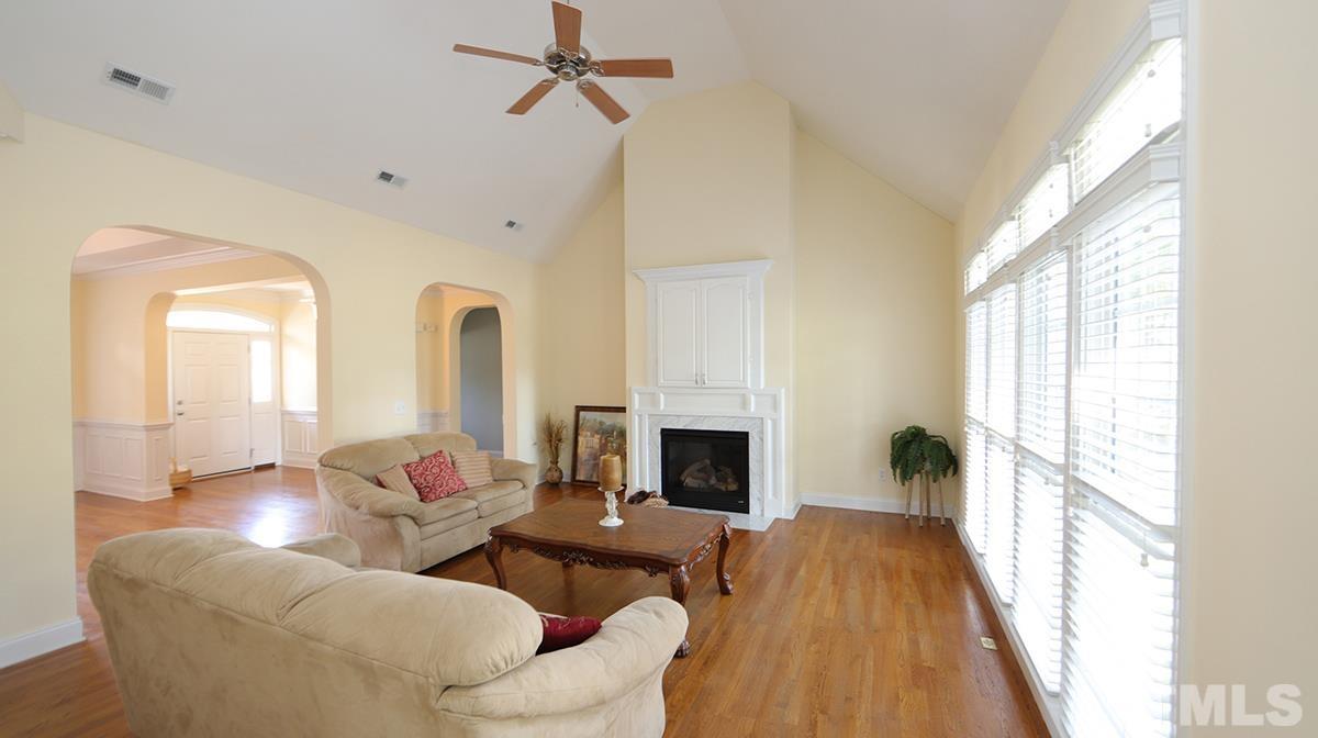 263 Waterville Street Raleigh, NC 27603 - Photo 6 of 18 a living room with furniture fireplace and a large window