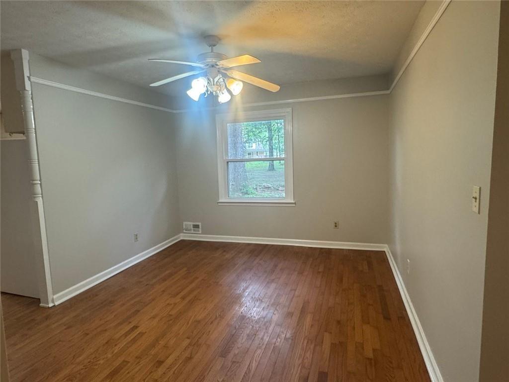 2550 Conyers Road McDonough, GA 30252 - Photo 13 of 29 an empty room with wooden floor and windows