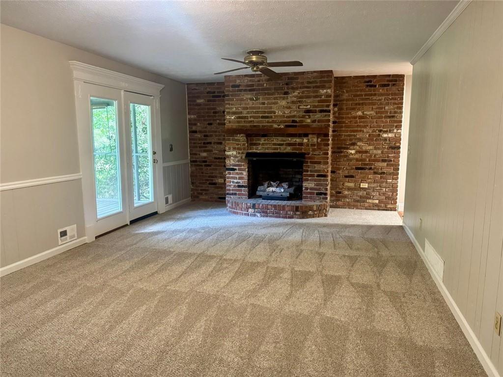 2550 Conyers Road McDonough, GA 30252 - Photo 17 of 29 a view of an empty room with a fireplace and a window