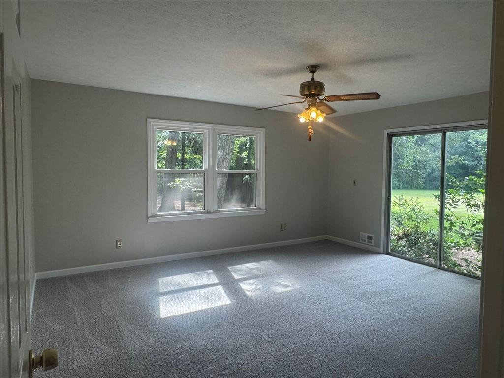 2550 Conyers Road McDonough, GA 30252 - Photo 19 of 29 an empty room with windows and fan