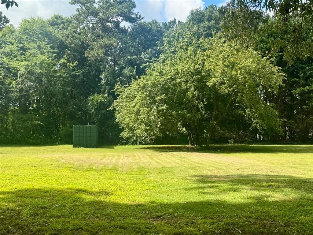 2550 Conyers Road McDonough, GA 30252 - Photo 5 of 29 a view of a swimming pool with an outdoor space and seating area