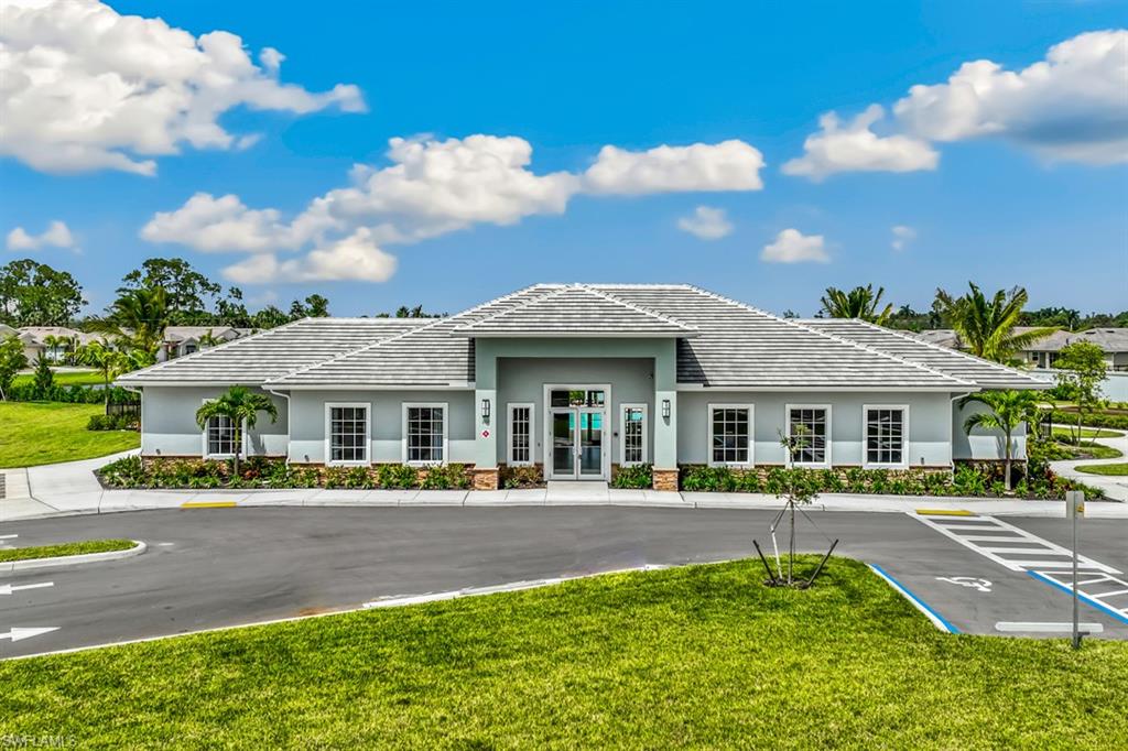 400 Grace Bay Lane Naples, FL 34114 - Photo 8 of 42 a front view of a house with a yard