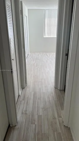 a view of a hallway in a house with window