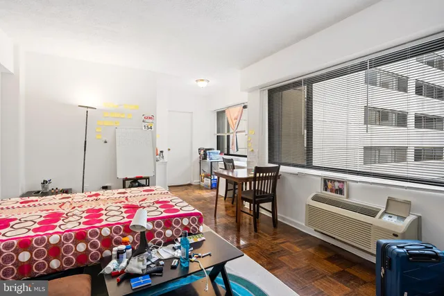 a bedroom with a bed and a table