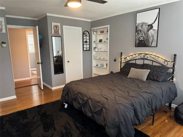 a bedroom with a bed and wooden floor