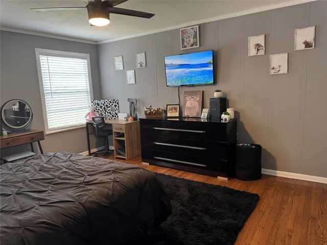 a bedroom with a bed and a desk in it