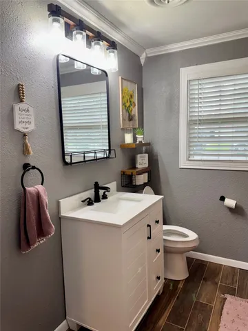 a bathroom with a toilet sink and mirror