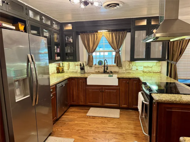 a bathroom with a granite countertop sink and a large mirror