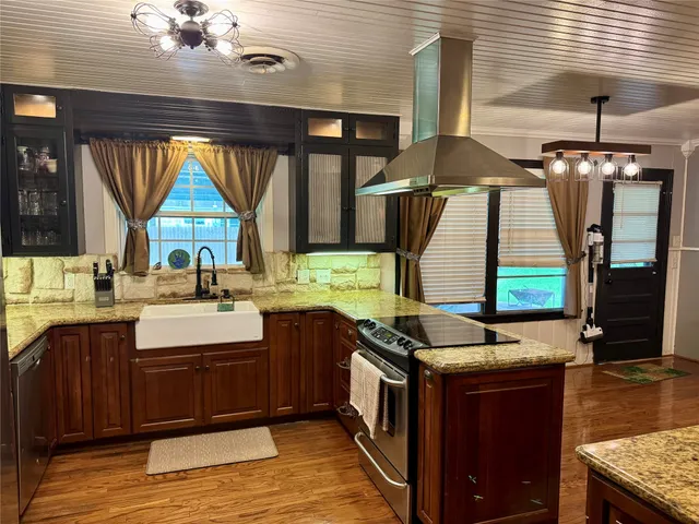 a kitchen with stainless steel appliances granite countertop a stove and a sink