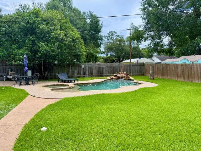 a swimming pool with lots of tress in front of it