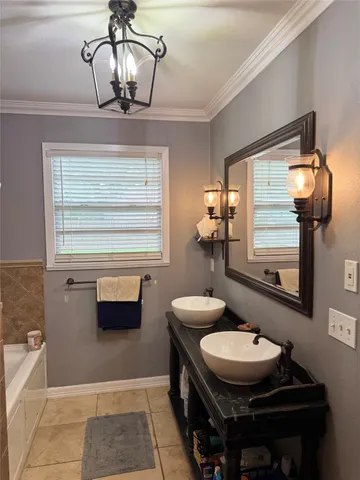 a bathroom with a sink a mirror and window
