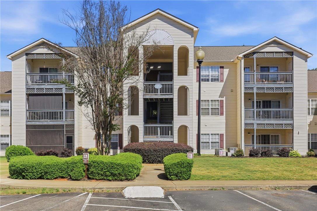 This multi-story residential building features inviting balconies and well-maintained landscaping.