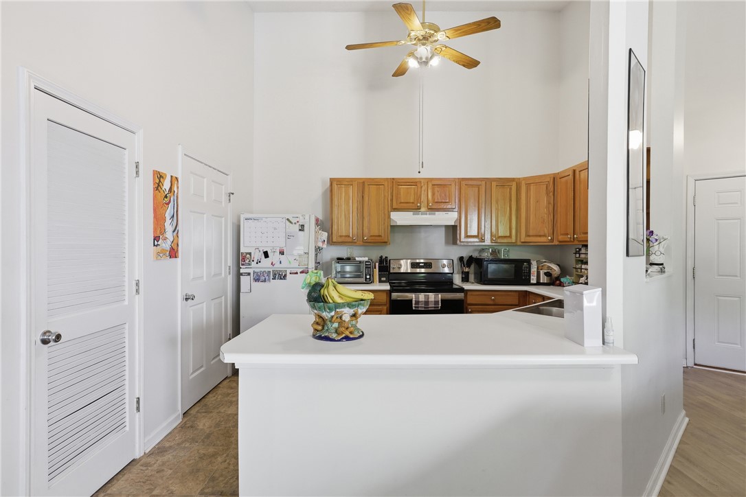 131 Wexford Drive Anderson, SC 29621 - Photo 11 of 25 This kitchen features a practical layout with warm wood cabinetry and a convenient breakfast bar.