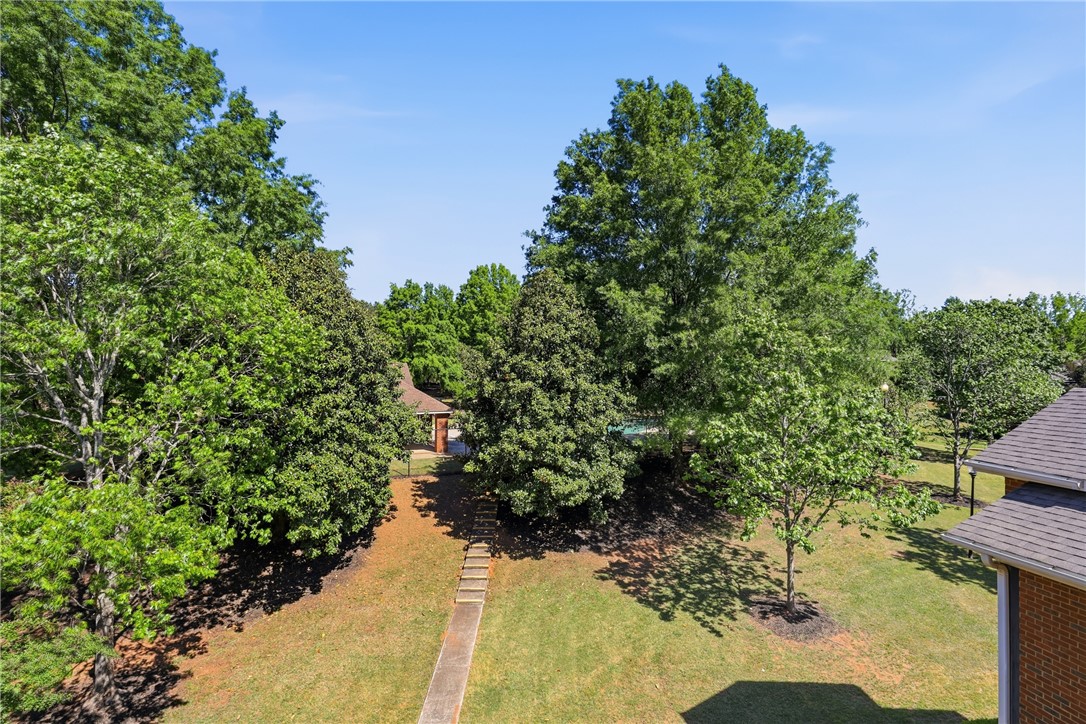 131 Wexford Drive Anderson, SC 29621 - Photo 24 of 25 A tranquil yard with lush trees and a paved walkway leading to a charming gazebo.
