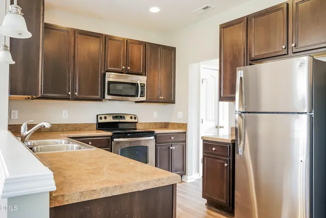 a kitchen with a refrigerator stove and microwave
