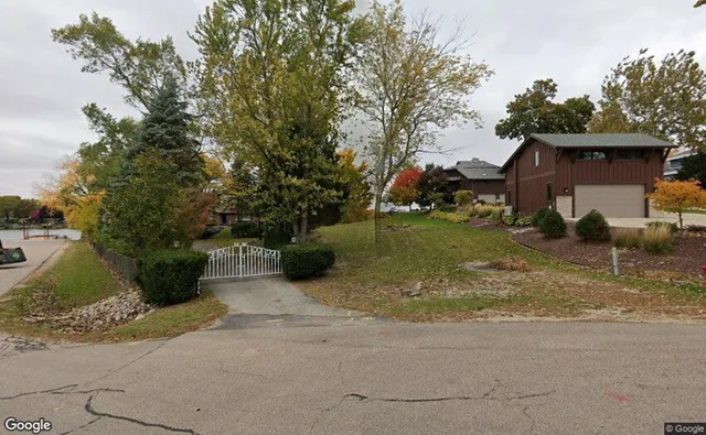 a view of a house with backyard and a tree