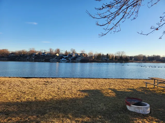 a view of a lake with houses in the back