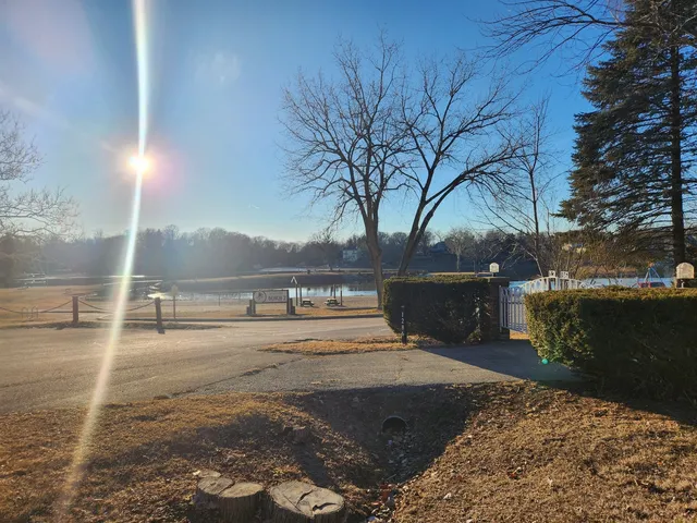 a view of a yard with wooden fence