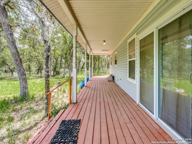 a view of a balcony with wooden floor