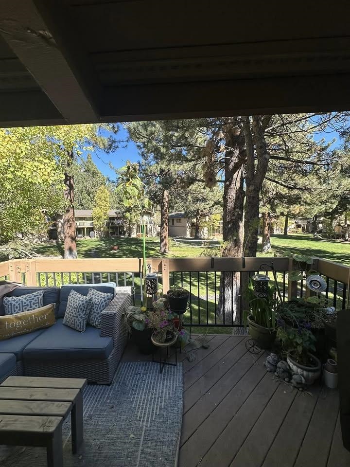 3252 Chateau Road, Unit 43 Mammoth Lakes, CA 93546 - Photo 10 of 29 Spacious outdoor deck featuring wood decking, a black metal railing, and a wood-finish overhead beam