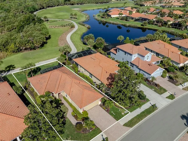 an aerial view of a house with a garden and swimming pool