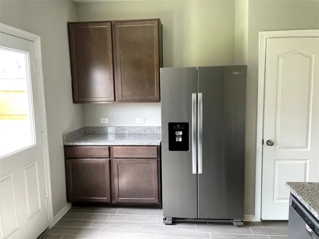 a kitchen with metallic refrigerator freezer and a dishwasher