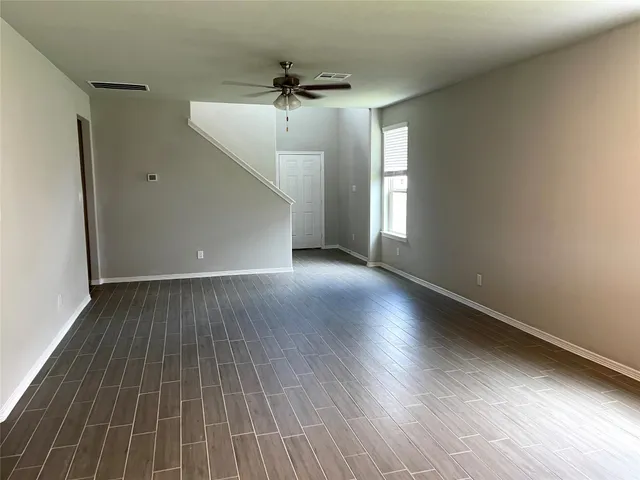 wooden floor in an empty room with a window
