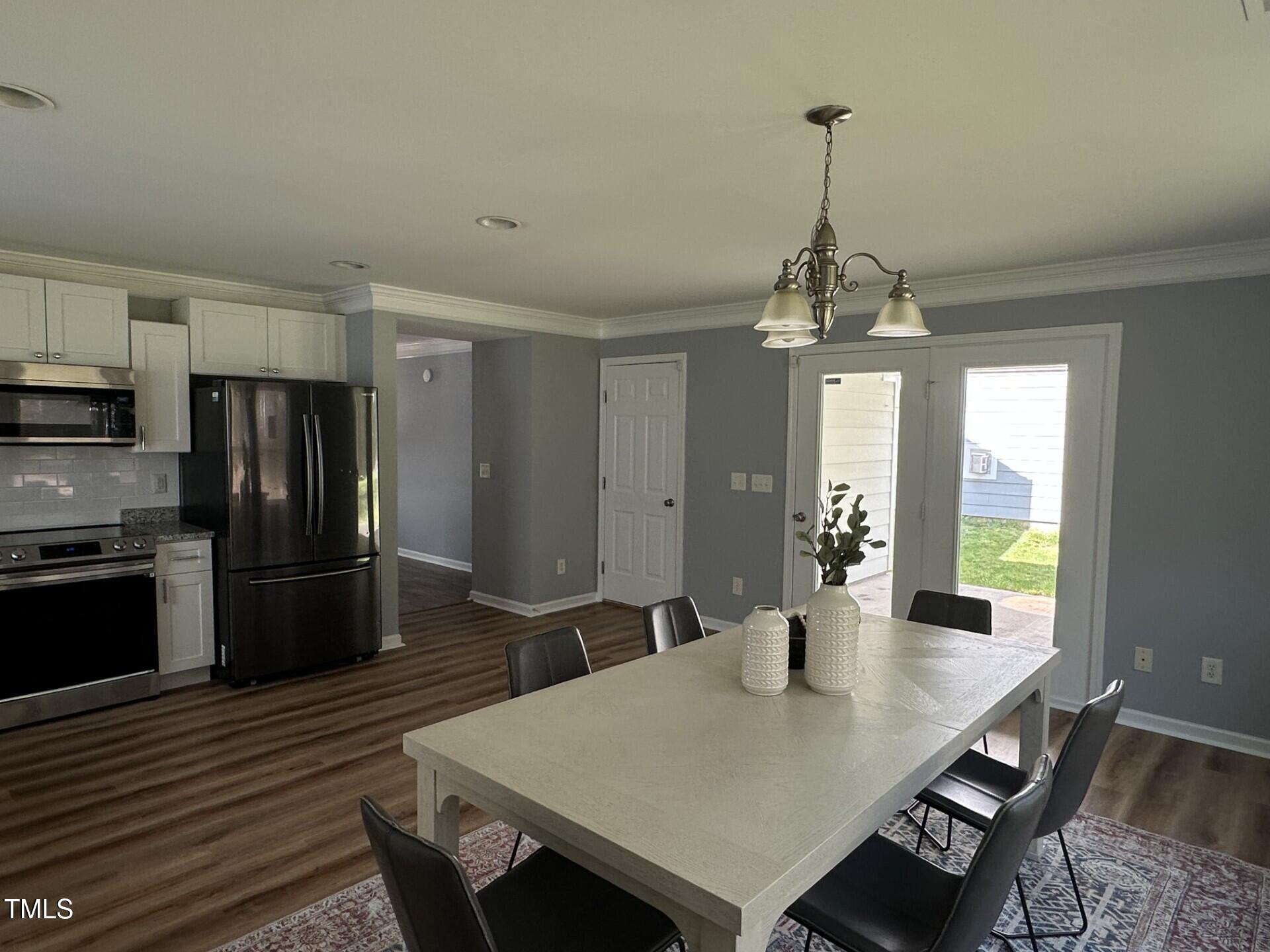 336 New Milford Road Cary, NC 27519 - Photo 12 of 53 a large kitchen with sink a refrigerator and wooden floor