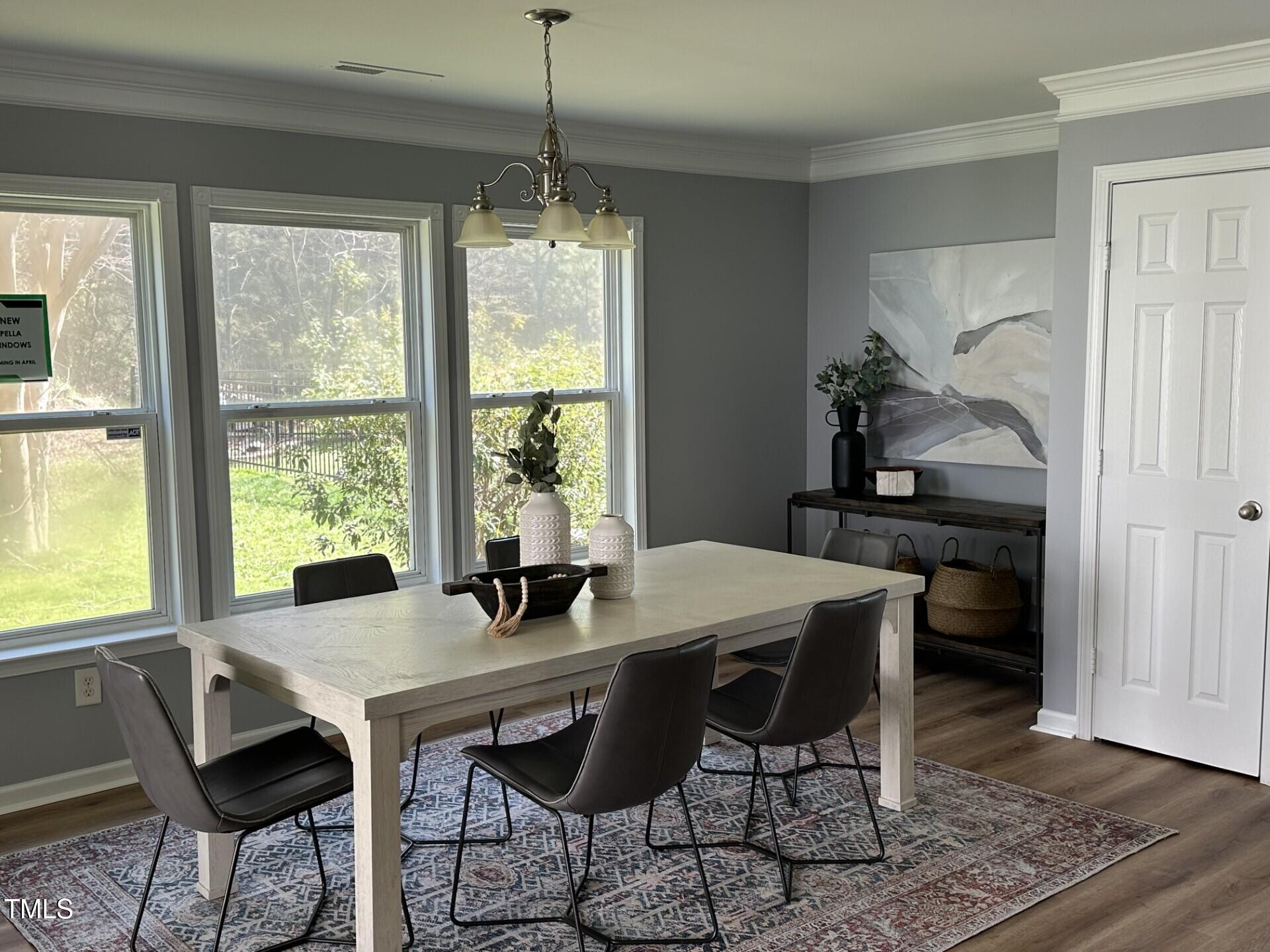 336 New Milford Road Cary, NC 27519 - Photo 13 of 53 a view of a dining room with furniture window and wooden floor